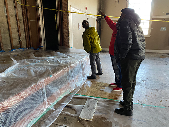 Historic preservation experts discuss options for the BWEL’s fire-damaged ballroom with Louis McLeMore, the lodge’s Exalted Ruler. Photo by Katelyn Van Genderen.